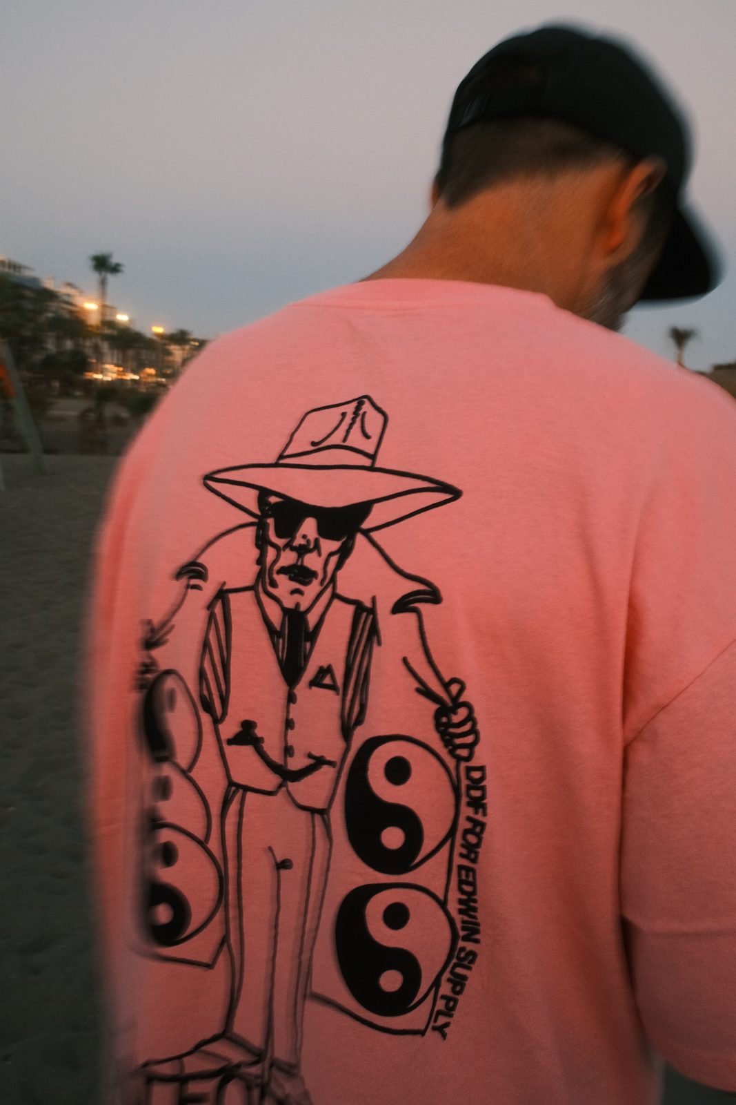 HENK × Edwin Supply tee on the beach
